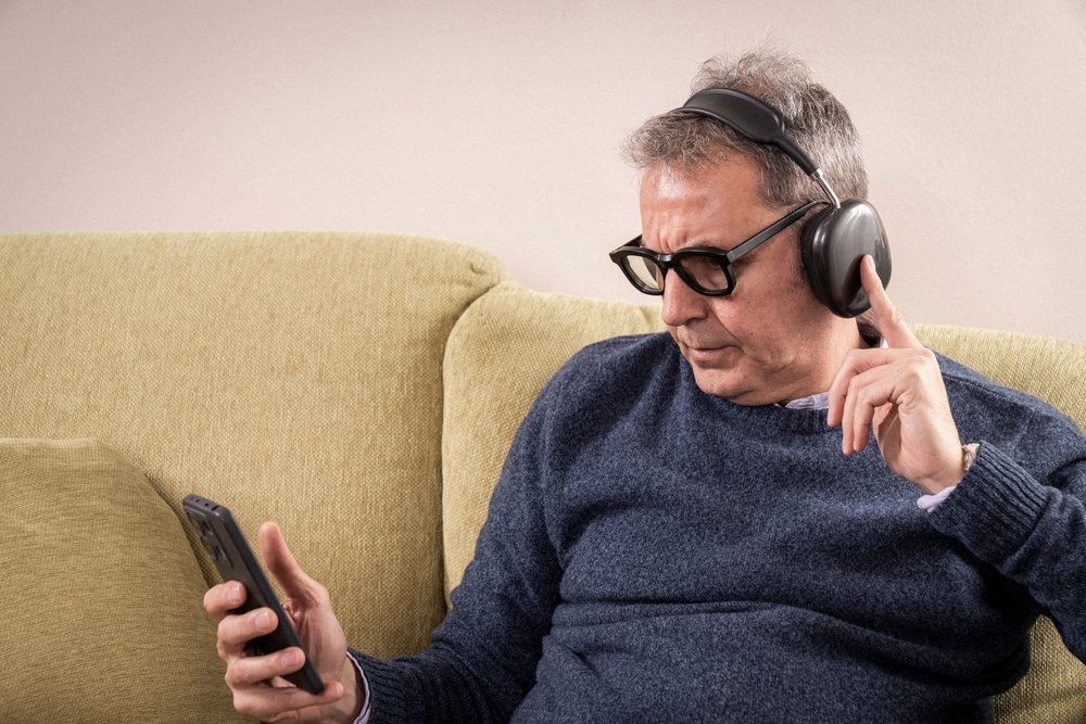 Home mature,man,with,eyes,closed,or,looking,down,,listening,to