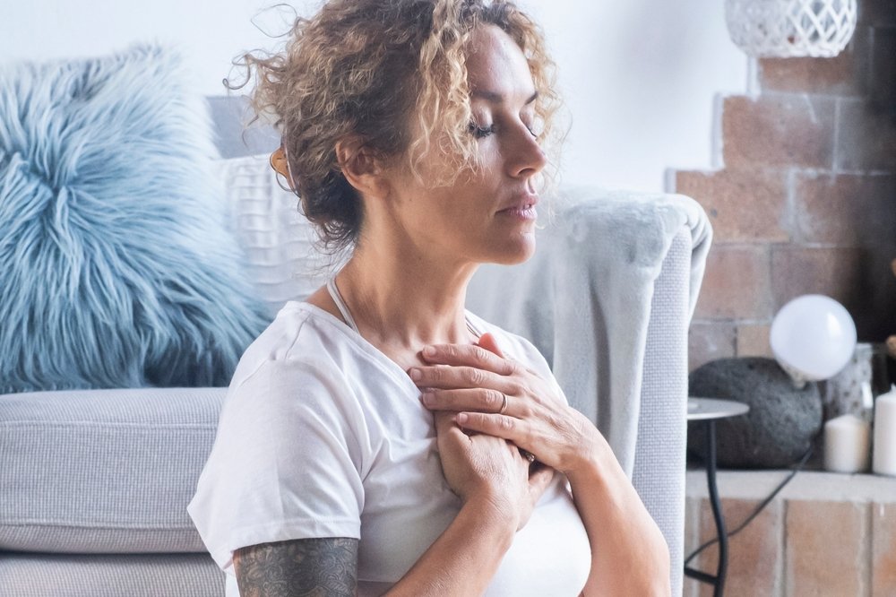 Home woman,at,home,meditating,in,lotus,position,,practicing,yoga,and